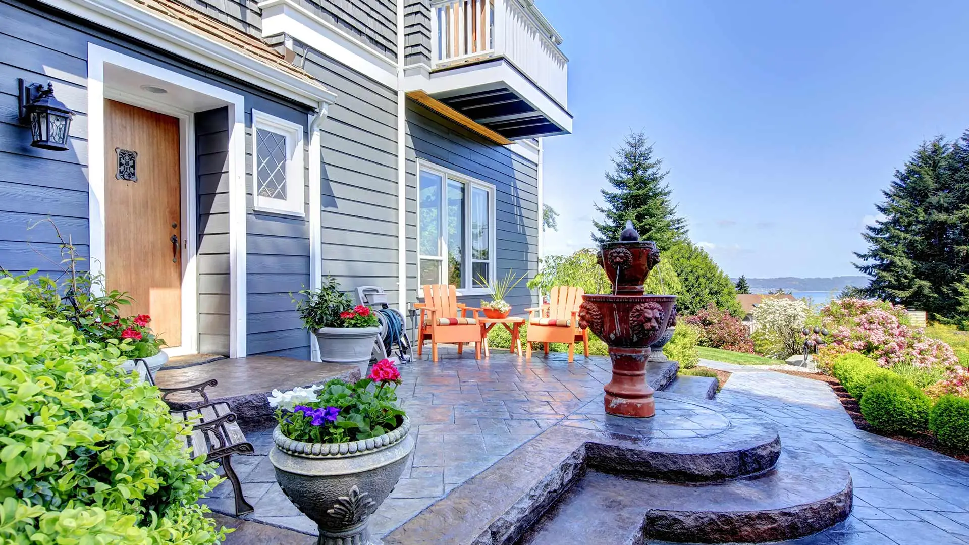 A blue home with newly installed patio and landscaping in Washington County, NE. 