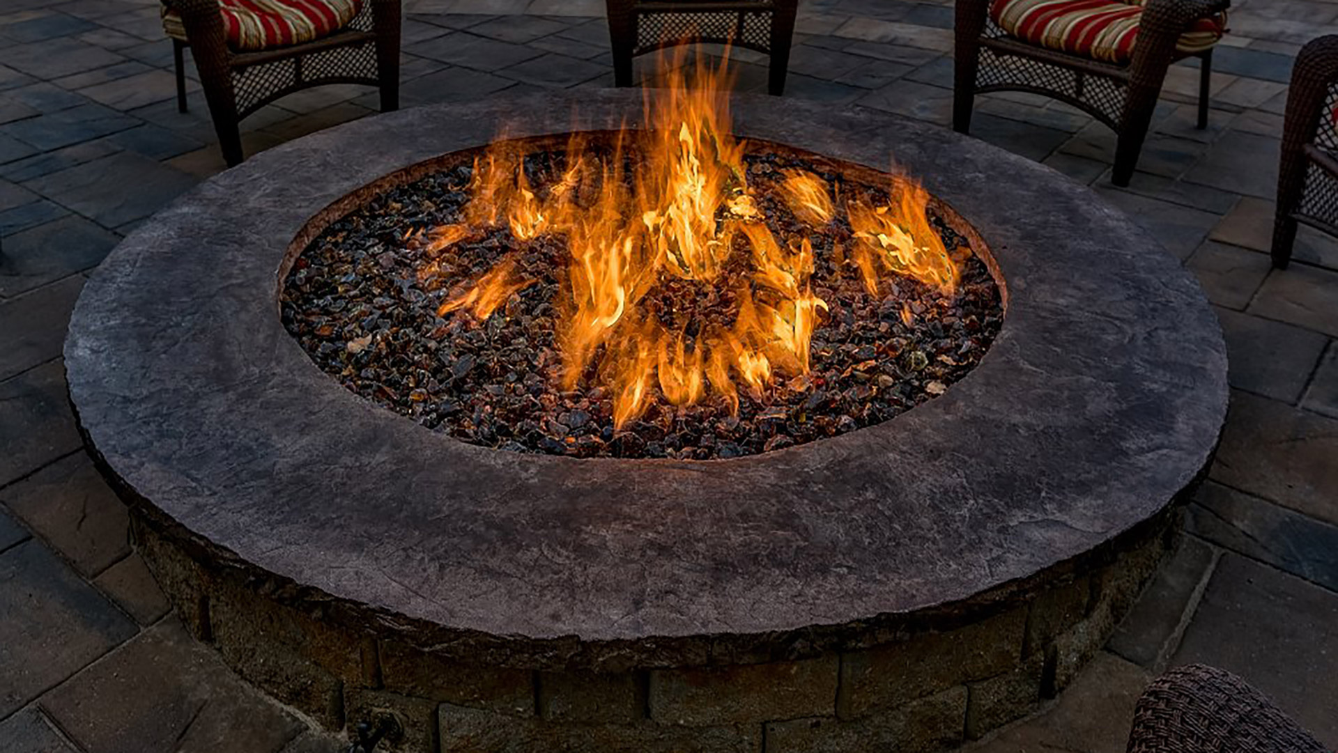 Fire in a round custom fire pit in Papillion, NE.