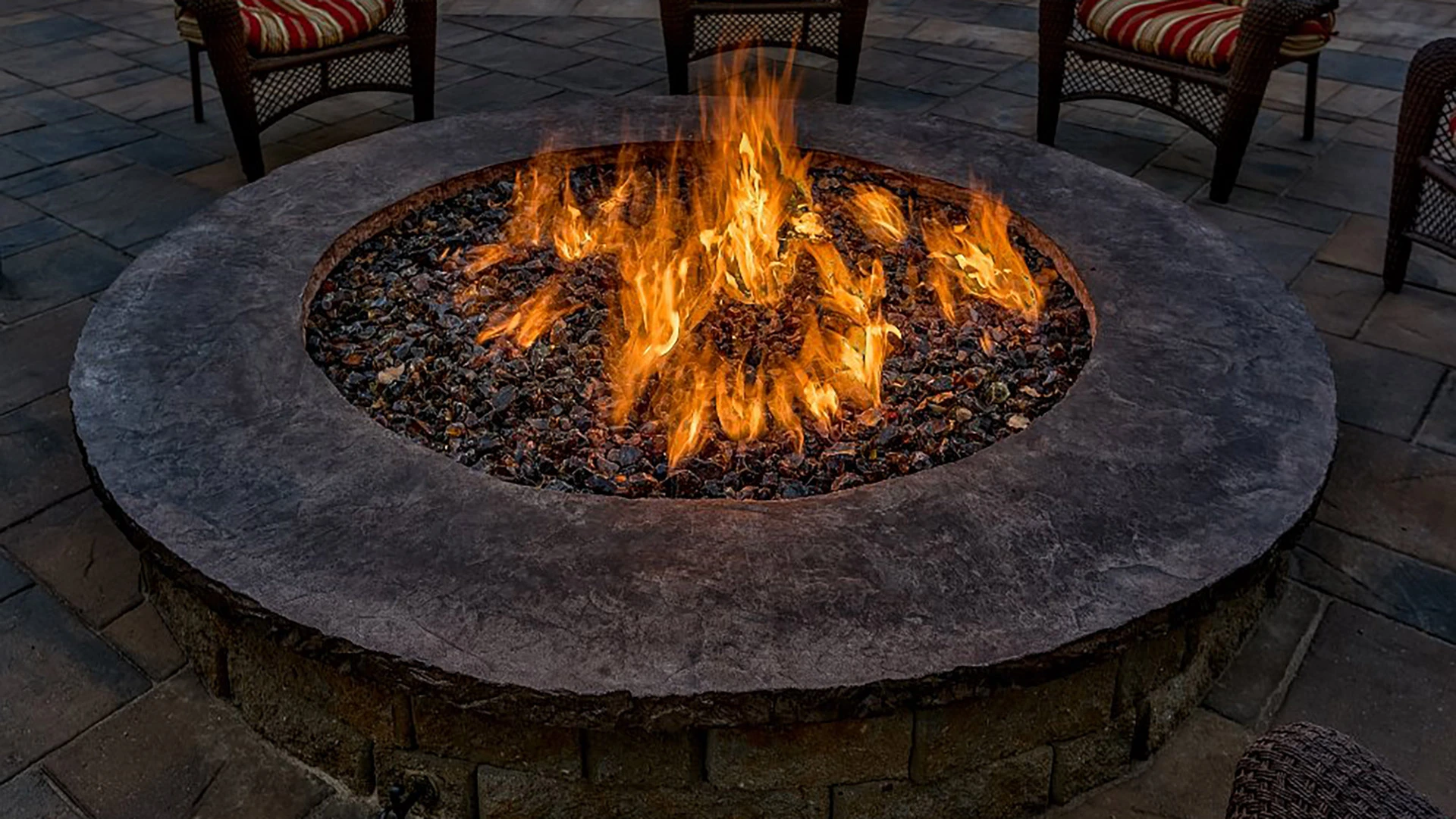 Fire in a round custom fire pit in Papillion, NE.