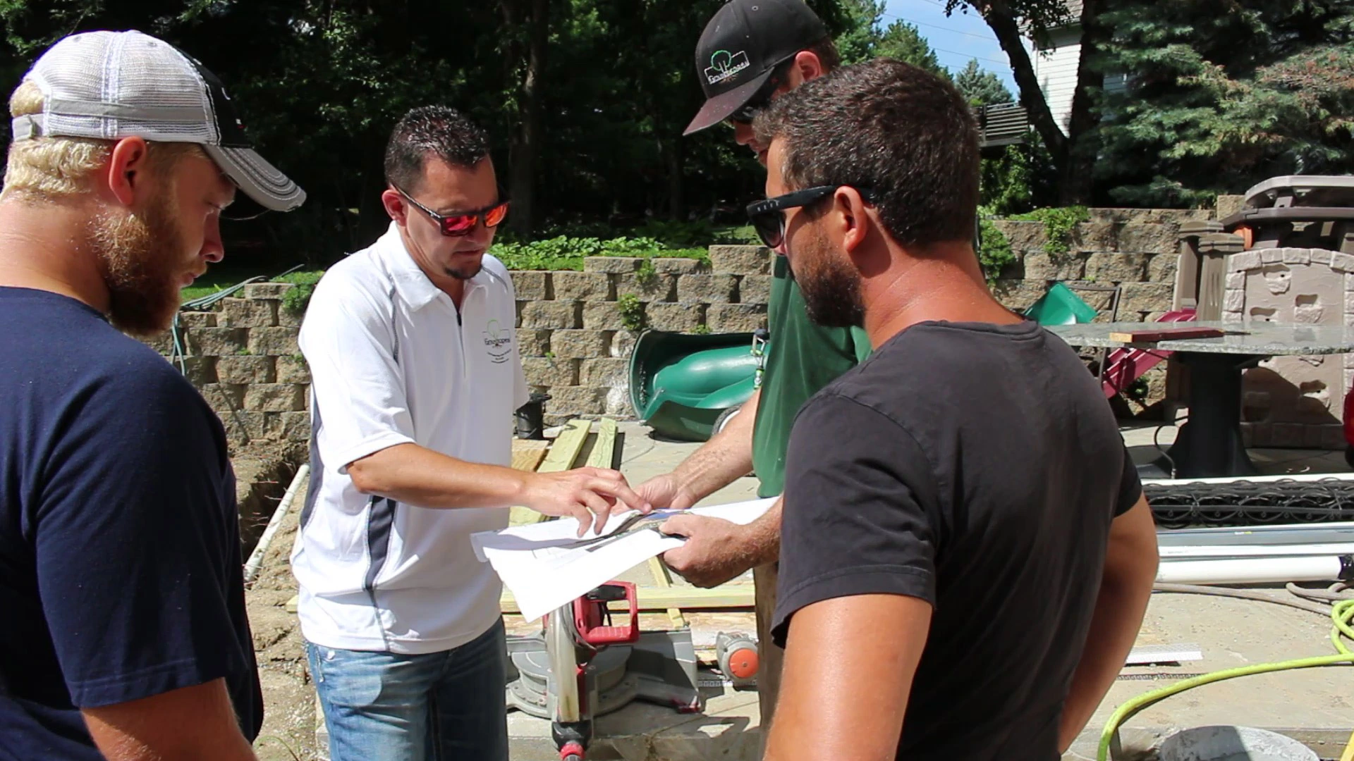 Our landscapers looking at design plans while working on a project in Bennington, NE.