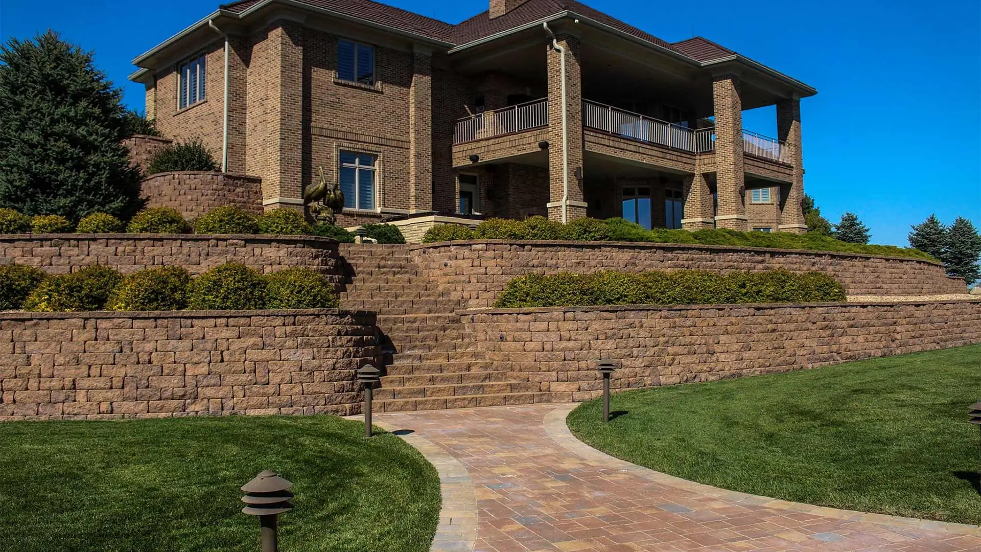 Multi-tiered retaining wall system around a home in Omaha, NE.