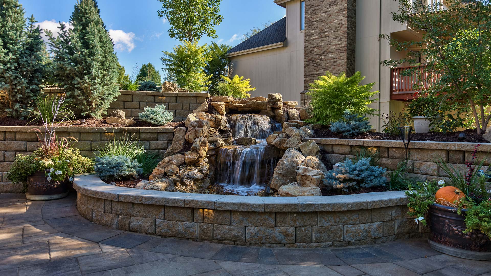 A pondless waterfall built with stone by a patio in Elkhorn, NE.