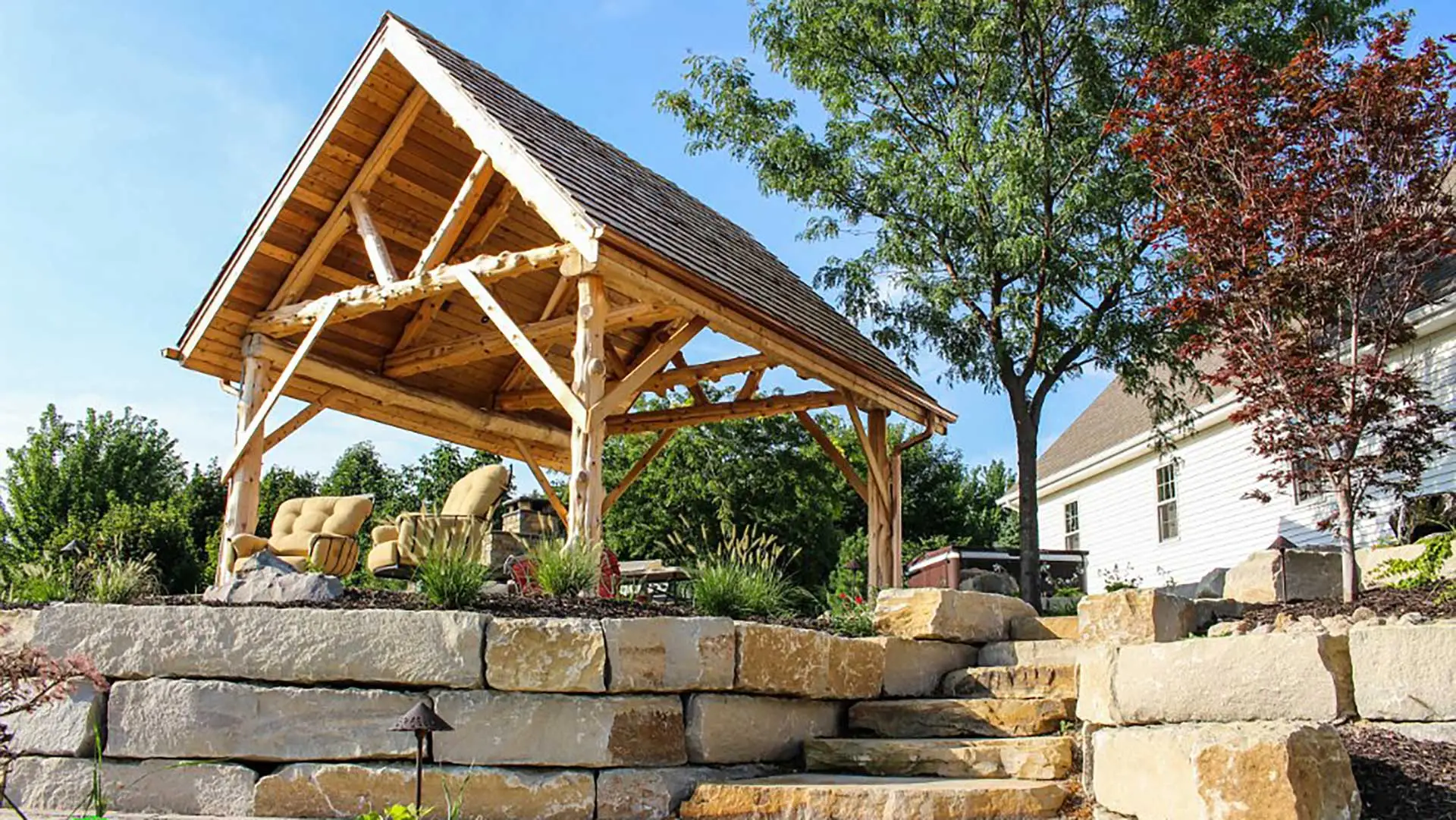 A raised patio with furniture under a pergola in La Vista, NE.