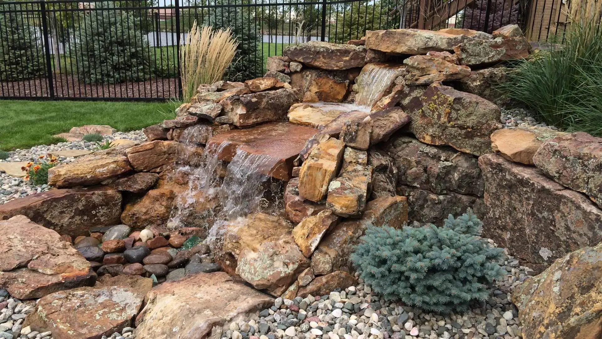 Waterfall over stones and rocks in Papillion, NE.