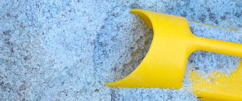 Deicing salt and a yellow scoop for use in Omaha, NE.