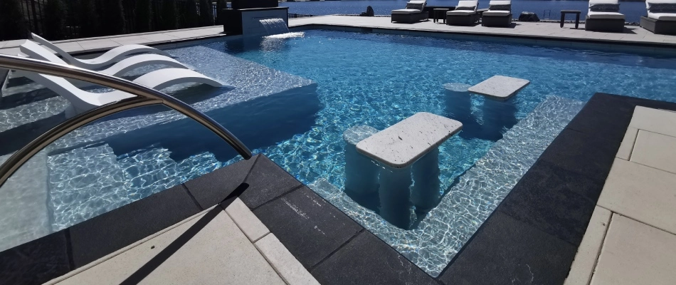 Bar stool seating area installed in a luxurious pool in Omaha, NE.