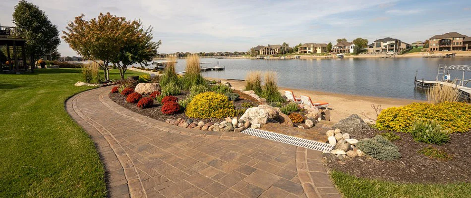 A landscape bed of healthy trees and shrubs by a home in Bennington, NE.