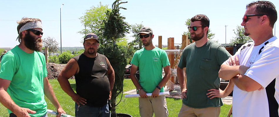 A group of our landscapers speaking about design plans at a project in La Vista, NE.