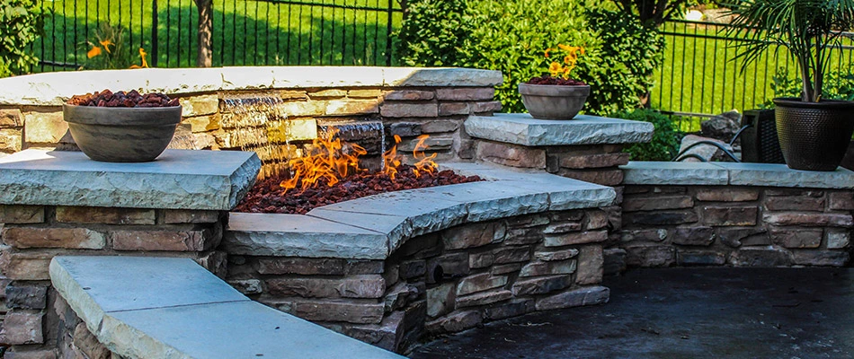 Content leveled seating wall featuring a water feature near Bennington, NE.