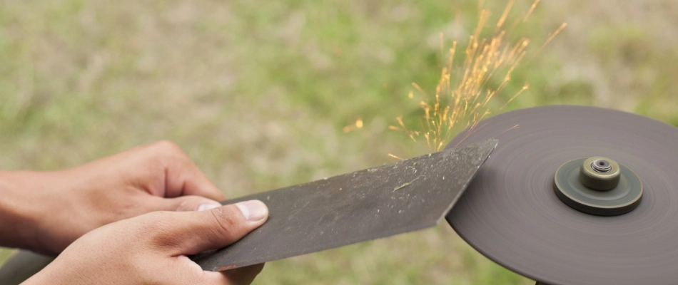 A mower blade being sharpen by a professional in Bennington, NE.