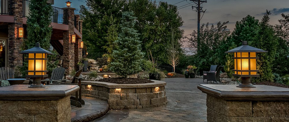 Outdoor living space with lighting and retaining and seating walls near La Vista, NE.