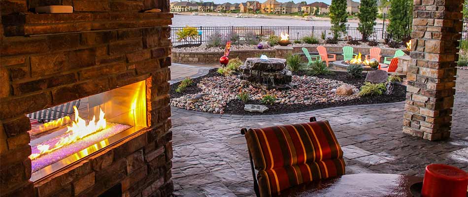 Outdoor living space with fireplace and patio in Omaha, NE.
