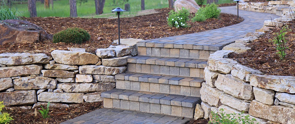 Outdoor steps built with stone pavers and surrounded by a retaining wall in La Vista, NE.