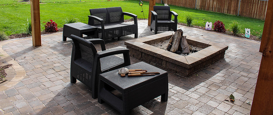 A custom patio and fire pit installed behind a home in Douglas County, NE.