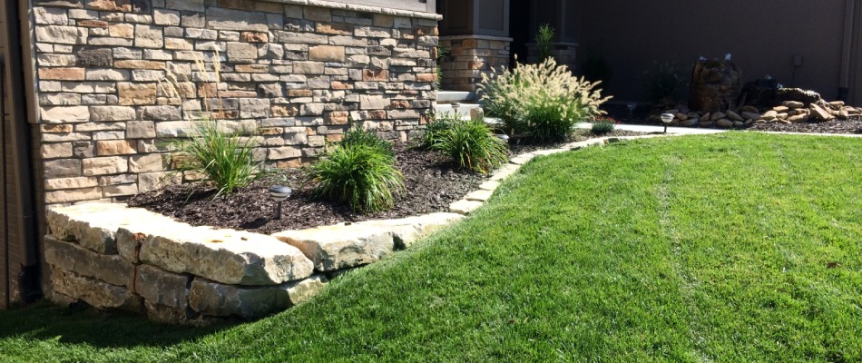 A retaining wall installed with a landscape bed in Papillion, NE.