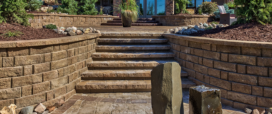 Retaining walls alongside a paved patio and stairs in Gretna, NE.