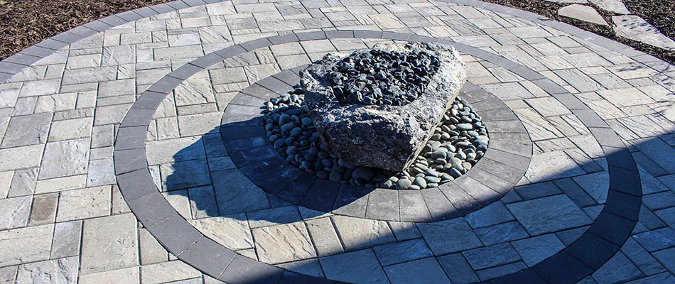 A unique rock fire feature on a paved patio in Waterloo, NE.