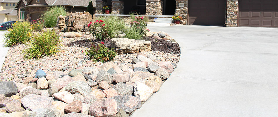 A landscape bed topped with rock in front of a home in Douglas County, NE.
