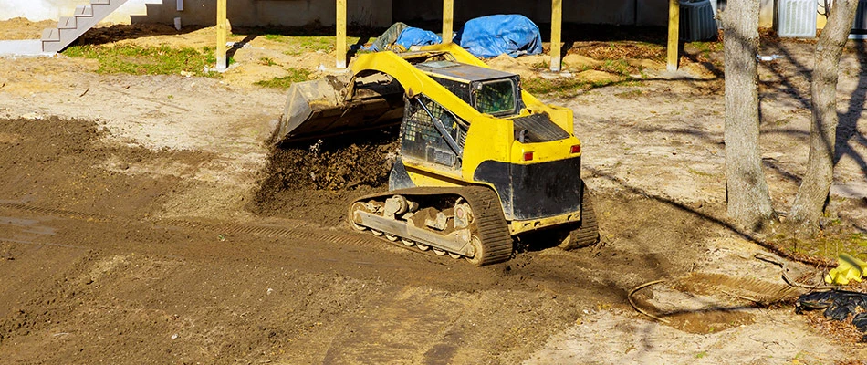 Skid loader grading a lawn near Omaha, NE.