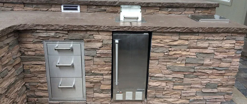 A stacked stone kitchen with silver appliances in Waterloo, NE.